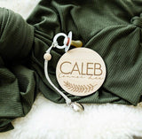 Baby Name sign on fur with swaddle and pacifier