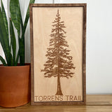Wall art featuring an engraved tree and text