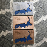 A group of three Spirit Lake Maps showing different stain colors - grey stain, natural birch, and walnut stain